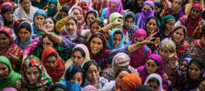 LARKIPUR , KASHMIR, INDIA - AUGUST 12: Kashmiri Muslim women shout anti Indian and pro Kashmir freedom slogans as they mourn during the funeral of Bilal Ahmad Bhat, 23, a civilian who was allegedly shot dead by Indian paramilitary Border Security Force (BSF) on August 12, 2015 in Larkipur, 35 km (21 miles) south of Srinagar, the summer capital of Indian administered Kashmir, India. Hundreds of Kashmiris participated in the funeral of Bhat who was killed by the Indian paramilitary BSF after they allegedly opened fire on the protestors who were protesting against the killing of two Lashkar-e-Taiba (Army of the Righteous), one of the largest and most active militant organization operating in Indian administered Kashmir, militants in an gun battle in Rakh-e-Lajura village of south Kashmir district on 11 August 2015. (Photo by Yawar Nazir/ Getty Images)